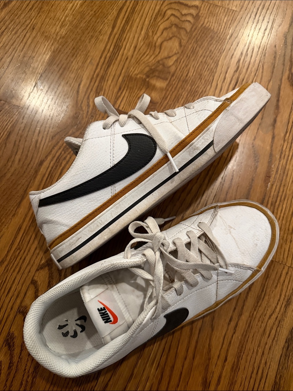 Nike White Low-Top Sneakers with Black Swoosh and Brown Accent